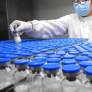 A technician inspects anti-cancer drugs in vials at a lab of a pharmaceutical company in Lianyungang, Jiangsu province, China March 13, 2019. REUTERS/Stringer ATTENTION EDITORS - THIS IMAGE WAS PROVIDED BY A THIRD PARTY. CHINA OUT.